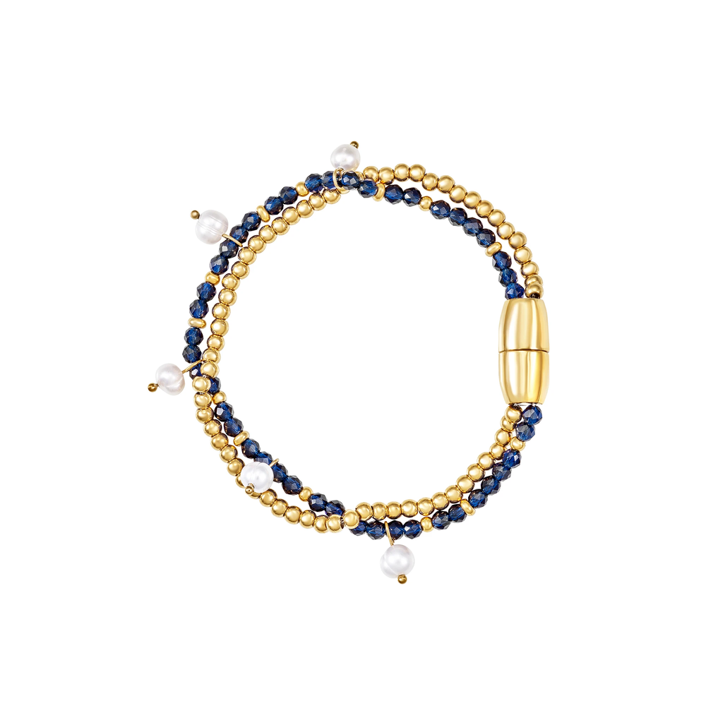 Bracciale Dunes and Stars da donna della collezione Magnetica System in acciaio Breil inossidabile con finitura PVD oro 14K, composto da una catena a microsfere e da un filo di cristalli blu impreziosito da 5 perle coltivate d'acqua dolce.